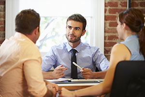 Couple Meeting With Financial Advisor In Office Tax pro with client